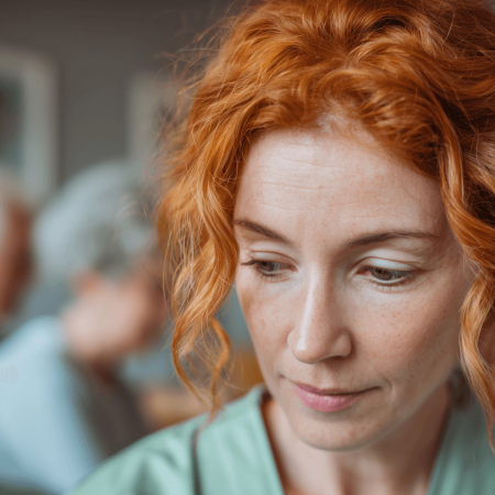 face of woman in workplace looking down, looking doubful
