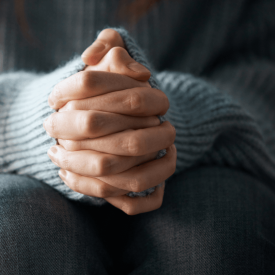 image if hands clasped and resing on knees