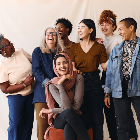 A group of women in a photo shoot, talking and laughing with each other